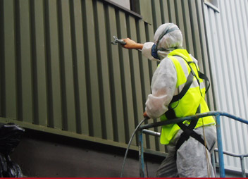 Picture of man spraying building